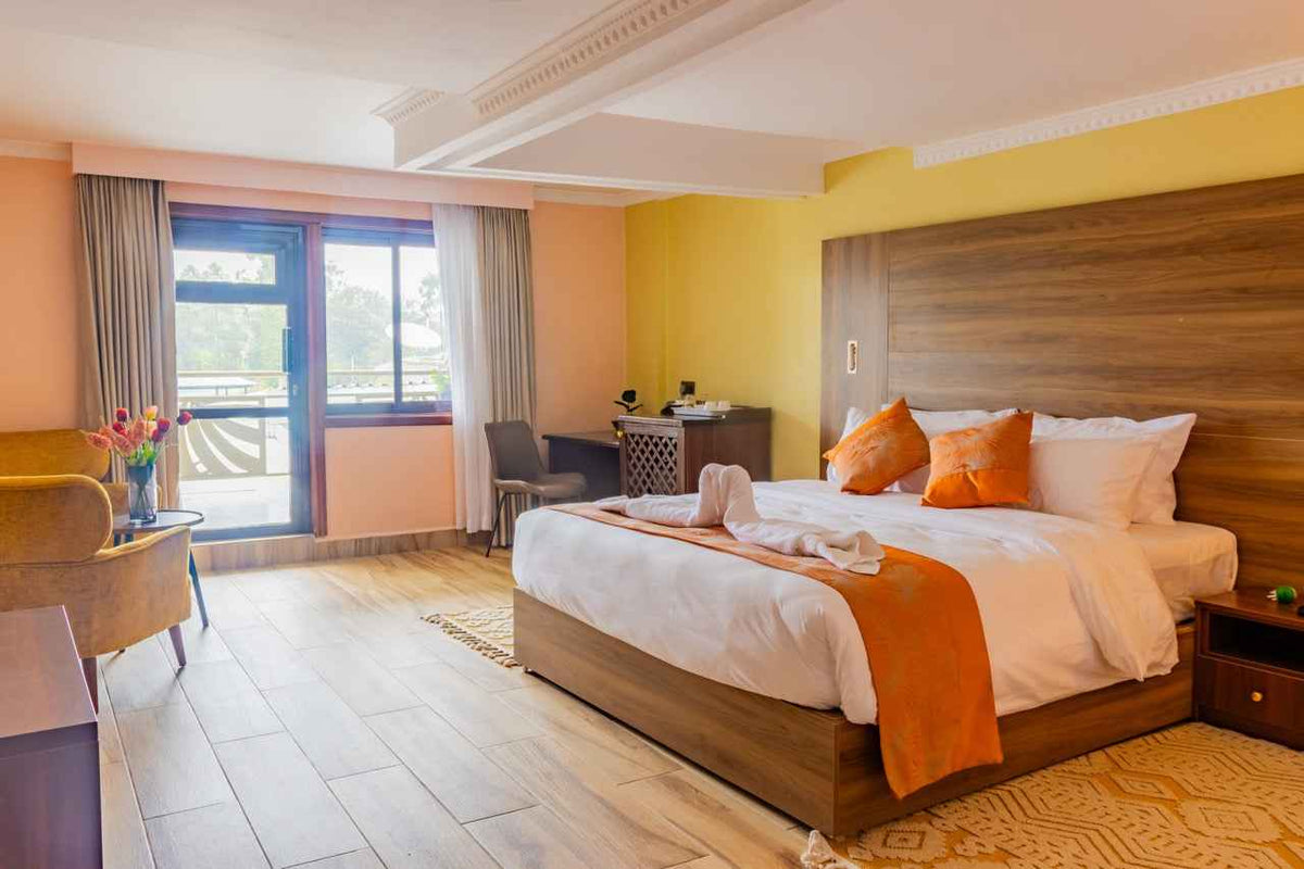 Guest room with orange runner and wooden headboard at Karen Plains Hotel, Karen, Nairobi, for a Mashujaa Day weekend