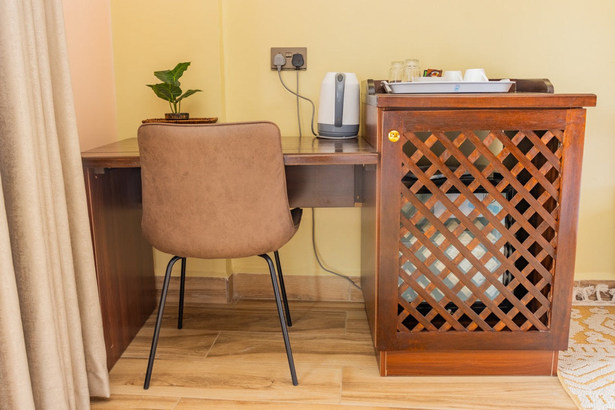 Work desk with chair and window light at Karen Plains Hotel, Karen, Nairobi, a quiet base for Nairobi business travel